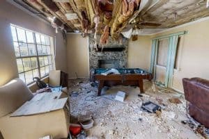 A room with severe ceiling damage and debris