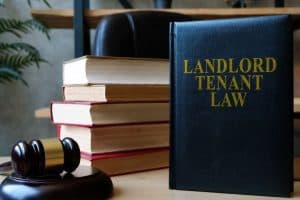 A Landlord Tenant Law book with a stack of books and a gavel