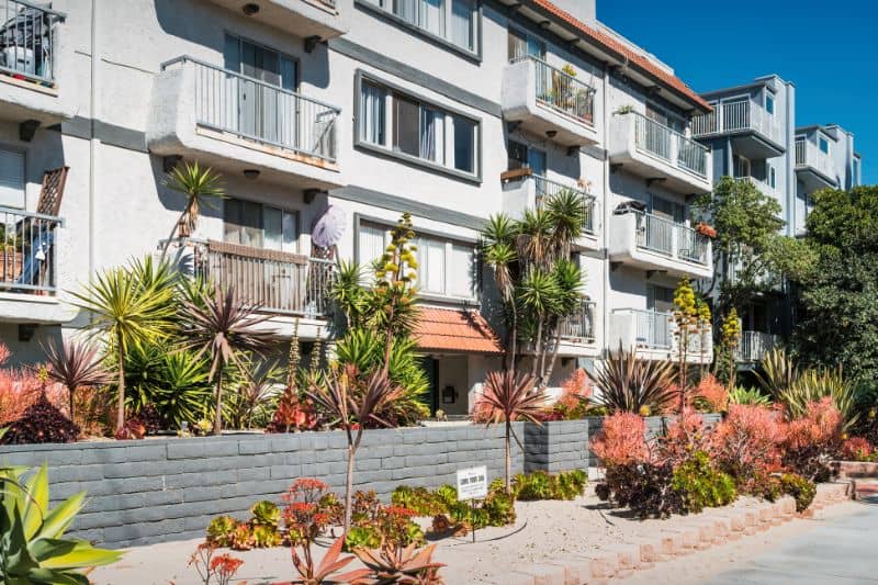 A modern apartment building exterior with landscaping