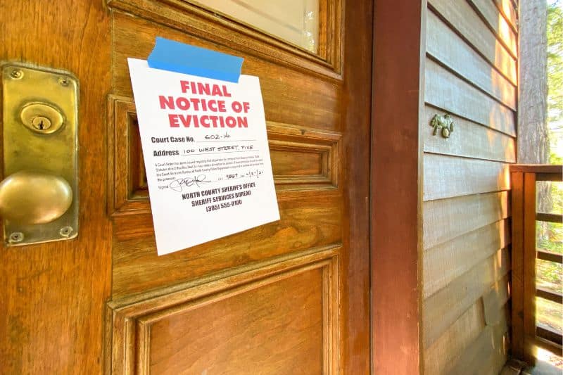 A Final Notice of Eviction taped to a wooden door