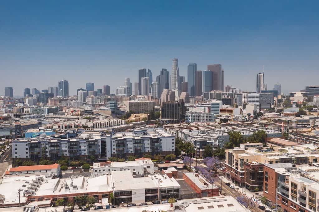 Aerial view of a dense Los Angeles cityscape with the downtown skyline