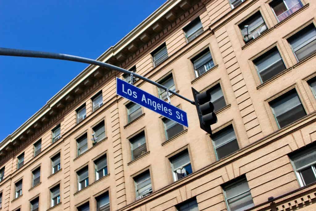 A Los Angeles Street sign in front of a historic downtown building