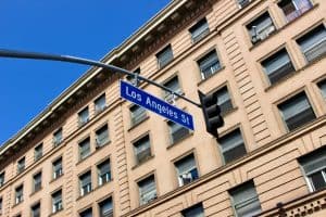 A Los Angeles Street sign in front of a historic downtown building
