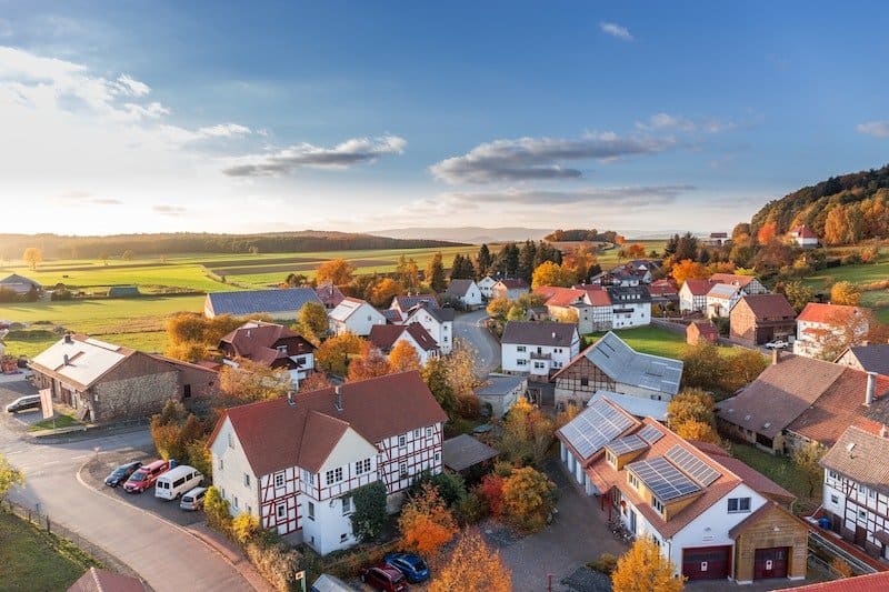 Aerial view of a suburban town with houses and autumn trees