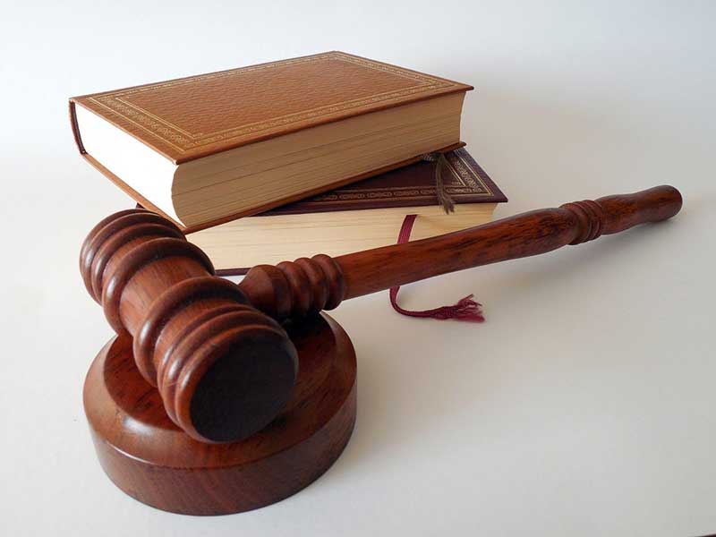 Stack of law books and a gavel representing new California rental laws in 2026