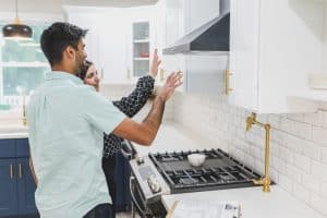 A man and woman having a discussion in a kitchen