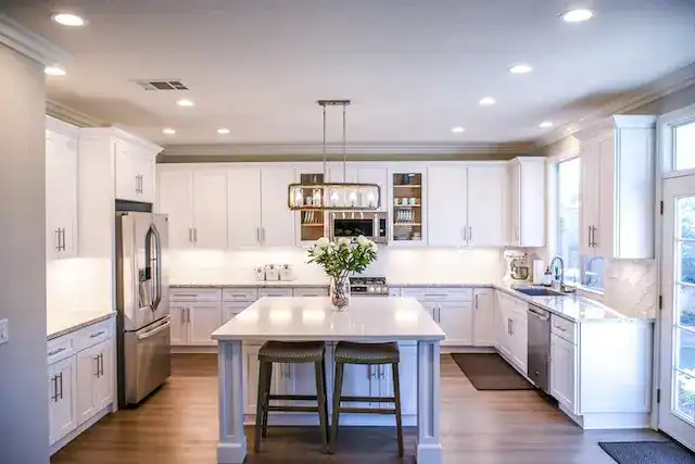 Modern renovated kitchen with white cabinets, a center island, and stainless-steel appliances